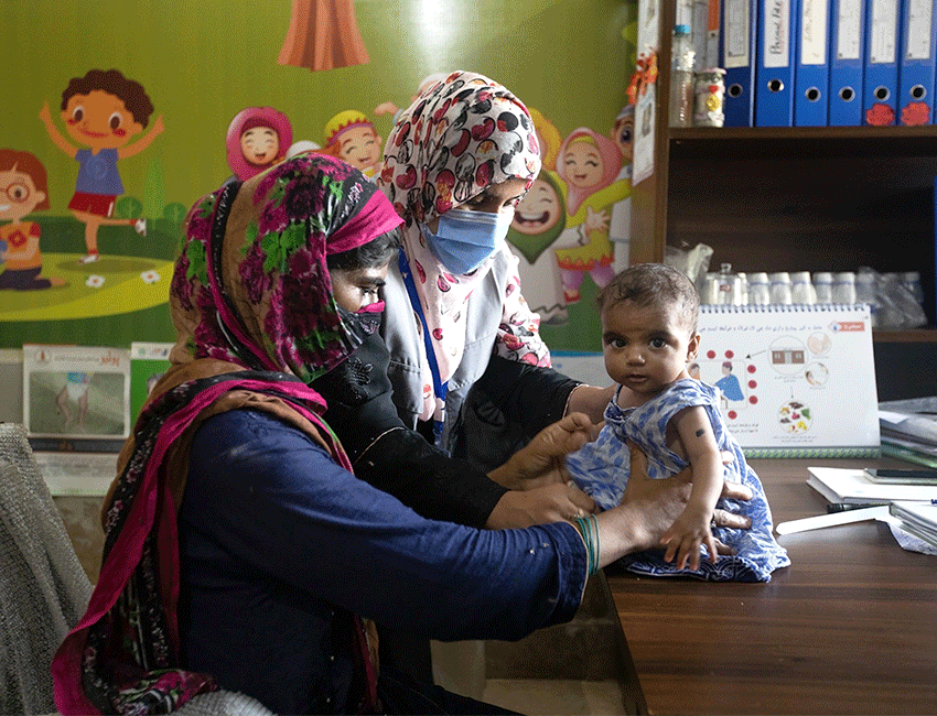 Young child being treated at an outpatient nutrition centre supported by Action Against Hunger in Pakistan