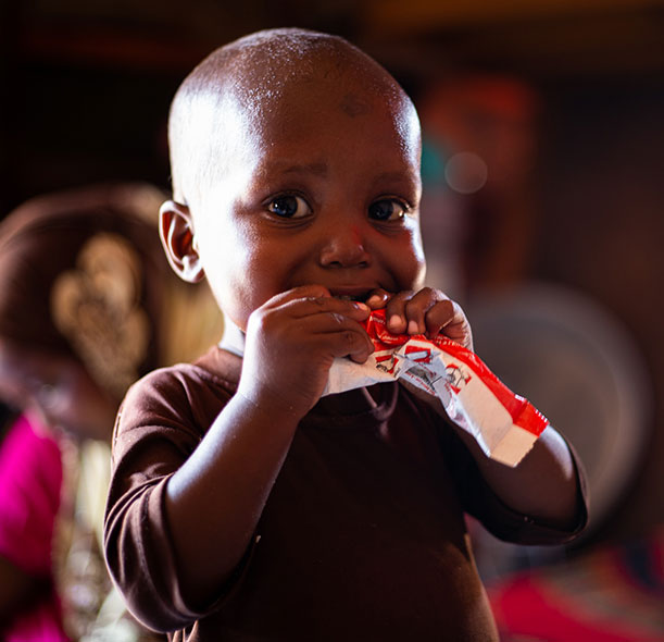 Mohamed eats ready-to-use therapeutic food at an Action Against Hunger stabilisation centre in Mogadishu, Somalia.