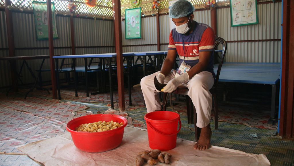 Farmer cutting up potatoes.