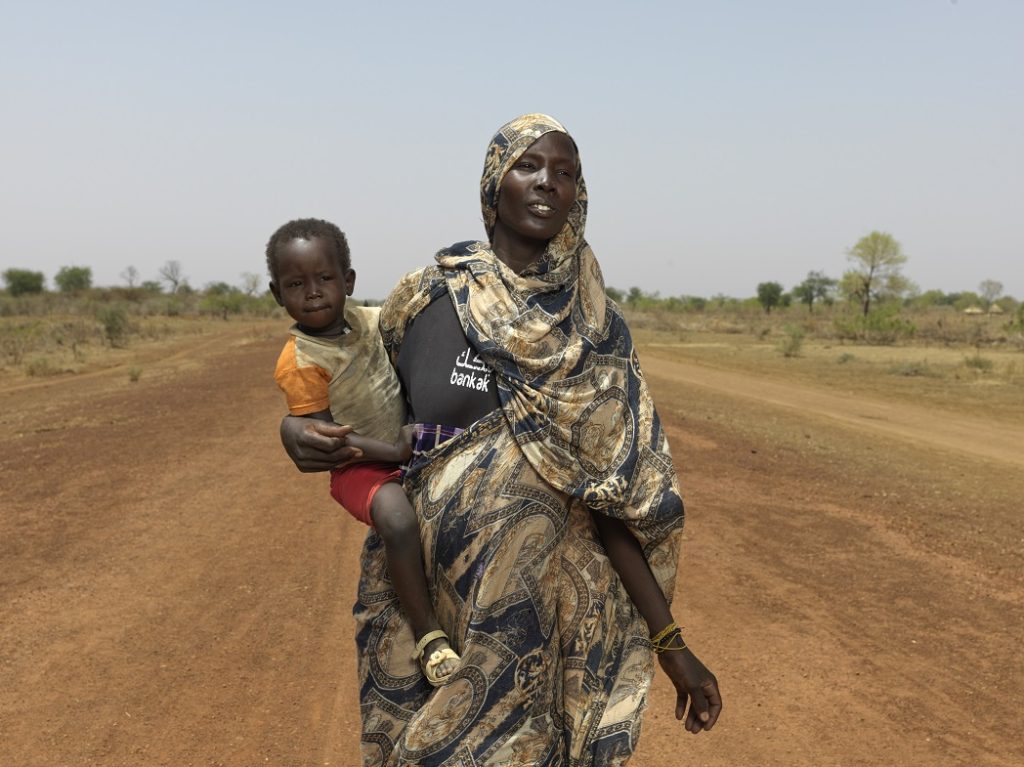 Nyibol Mathiang Deng arrives at the South Sudan border with her child