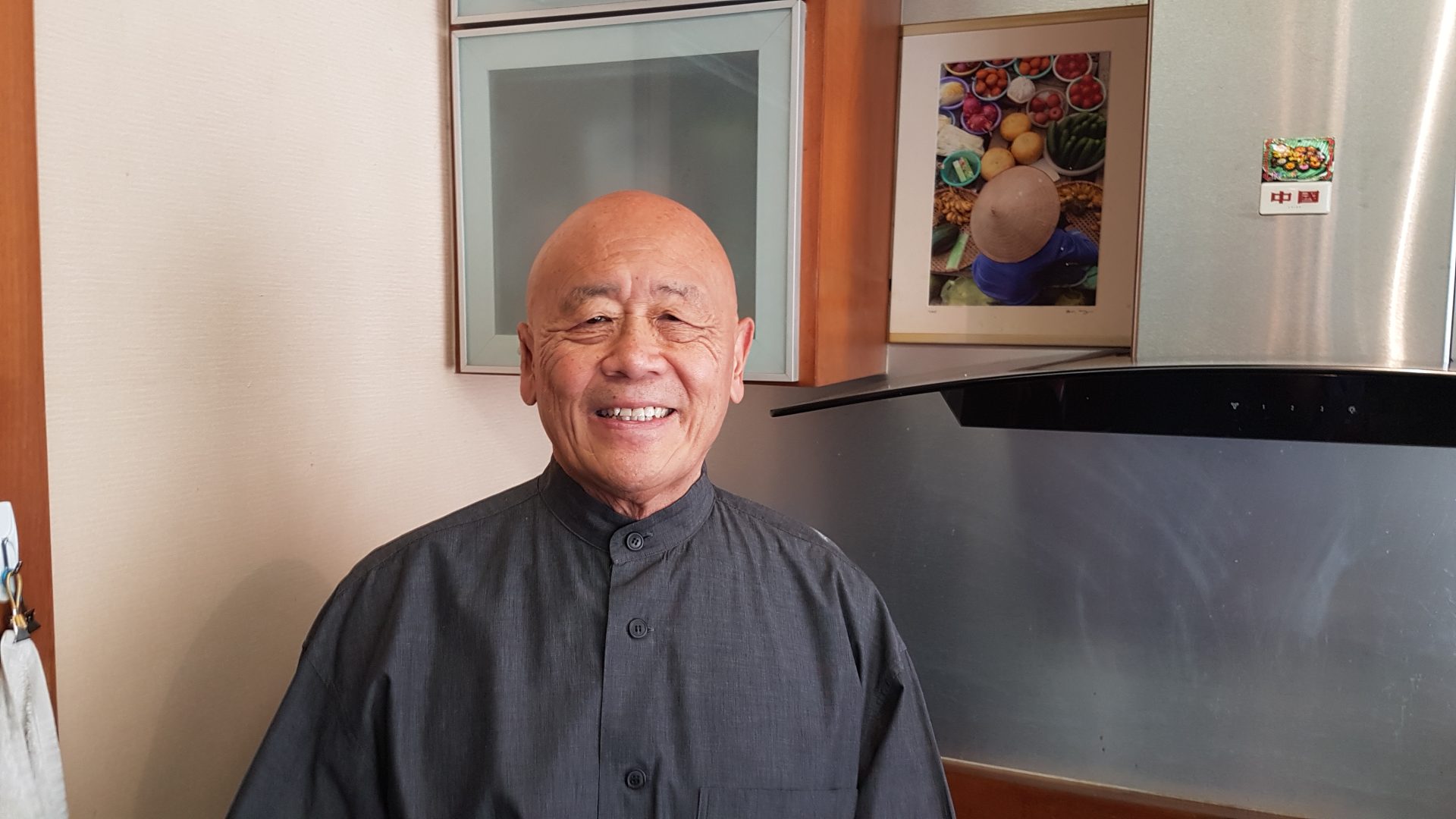 An image of chef Ken Hom smiling.