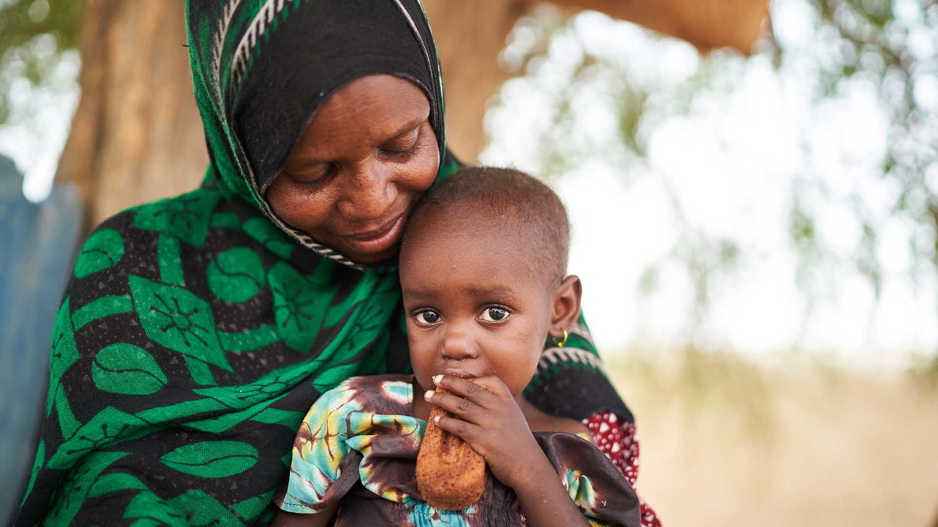 Portrait of Koubra with her mother Fatime. Action Against Hunger's team helped Koubra to recover from life-threatening malnutrition.