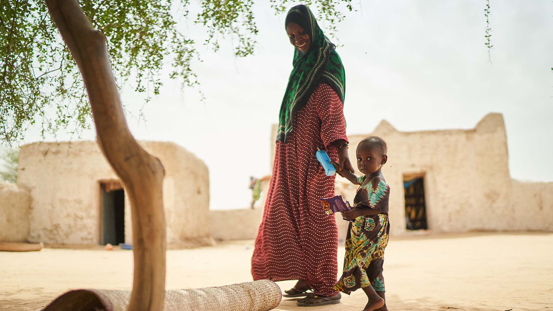 Koubra walks with her mother in Chad. Action Against Hunger's teams helped her to recover from malnutrition.