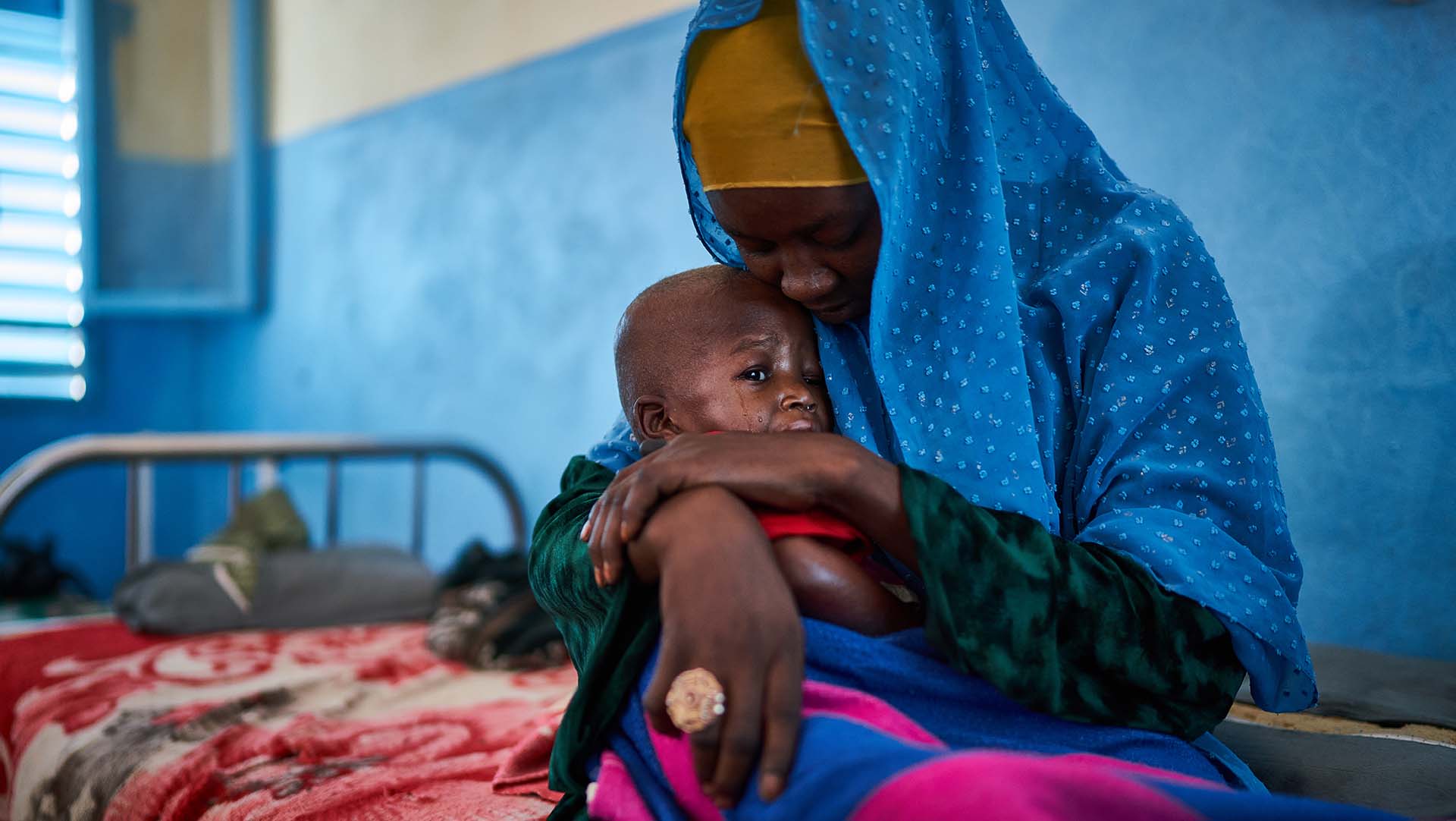 Moustafa with his mother at an Action Against Hunger health centre in Chad. Our team helped Moustafa recover from malnutrition.