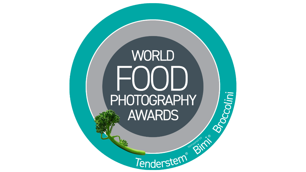 Circular logo for the World Food Photography Awards with teal and grey colours, featuring a broccoli sprig and sponsors.