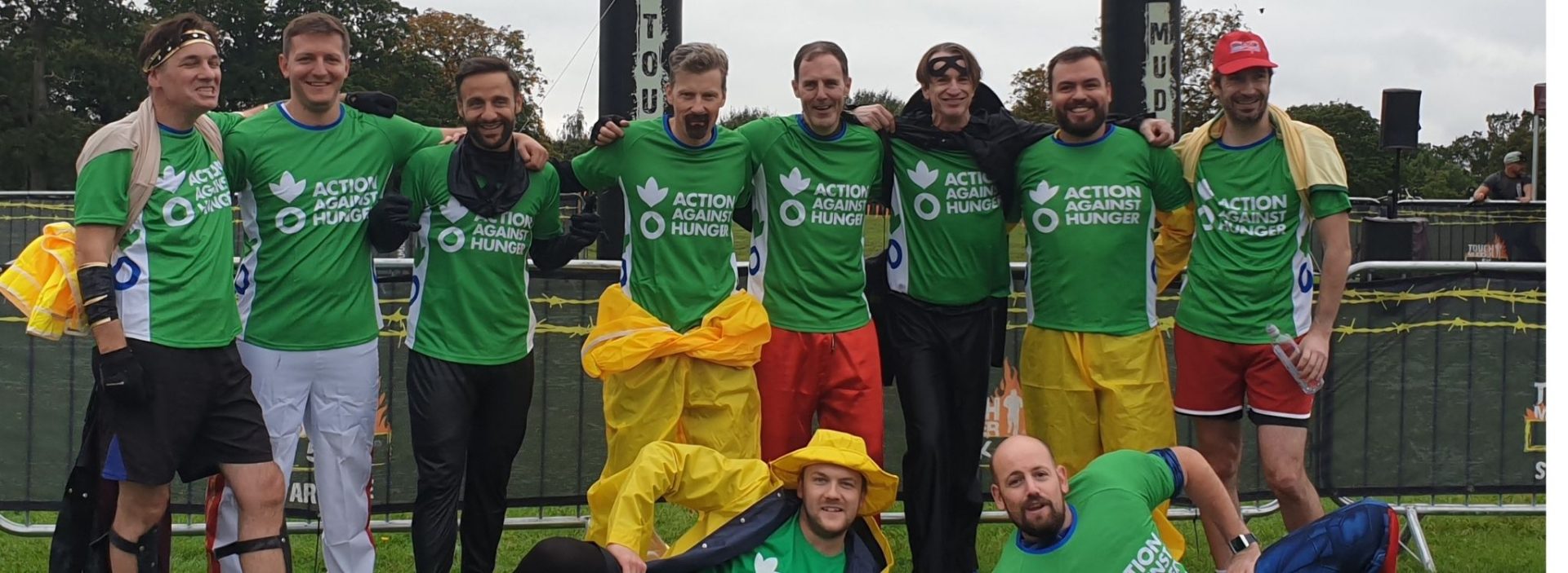 Group of fundraising superstars smiling in Action Against Hunger green t-shirts.